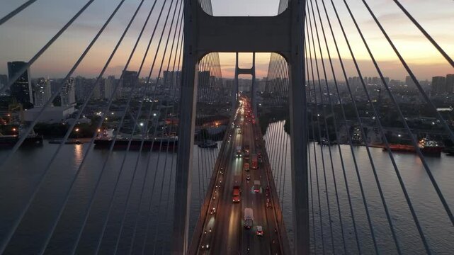 View of Phu My Bridge in Ho Chi Minh City at dusk with busy traffic and city skyline