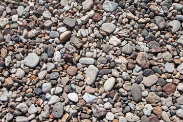 Small and medium sized white natural stones from a tropical beach, commonly used for garden decoration. Natural stone texture and background for graphic design.