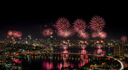 Fireworks over a city skyline at night.