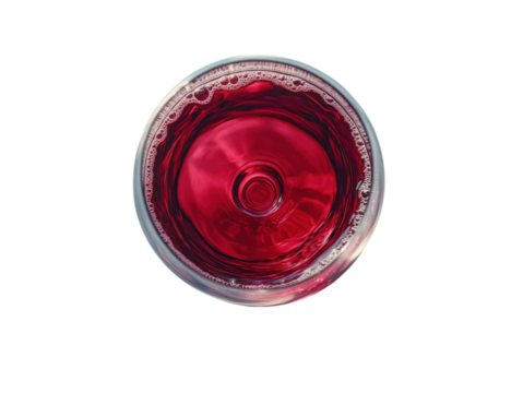 A glass of red wine is sitting on a white background