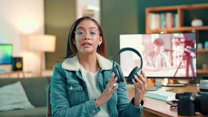 Headphones, live streaming and recording with face of influencer woman in home studio for broadcast. Creative, tech and video review with content creator at desk in apartment for product promotion