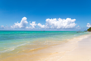 Beautiful Seascape: Calm Turquoise Ocean, White Sand Beach and Fluffy Clouds.Perfect Summer Getaway