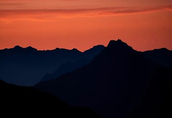 A dark silhouette of a rising mountain range representing financial growth, growth, range
