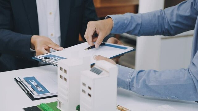 Lawsuits against Real estate agent and realtor general liability insurance businessman professional discussing and consultant with house toy model building before sign a contract with law concept