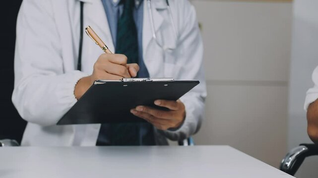 A stressed man consults a psychiatrist on family issues, love, work, and money, A psychiatrist is calming an Asian man suffering from depression in a medical clinic or hospital exam room office.