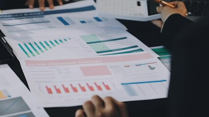 Auditor and accountant team working in office, analyze financial data and accounting record with calculator. Accounting company provide finance and taxation planning for profitable cash flow. Insight - Powered by Adobe