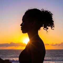 A serene woman stands on a sandy beach at sunset, her silhouette framed by vibrant hues of orange and pink, waves gently lapping at her feet.