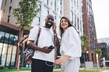 Stylish young woman walks while texting on smartphone, showing seamless tech integration, mobile...