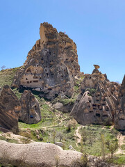 Uchisar Castle or Kalesi, a unique cave building, carved from volcanic rock at the highest point of...