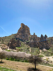 Uchisar Castle or Kalesi, a unique cave building, carved from volcanic rock at the highest point of...
