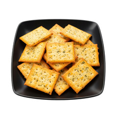 Fototapeta premium A black plate filled with golden-brown crackers sprinkled with herbs, set against a clean background