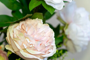 Soft pink peony flowers in a decorative arrangement