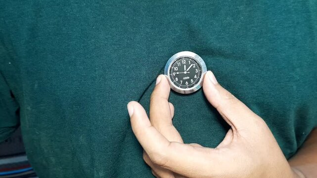 Man Holding a Working Wall Clock on His Chest Symbolizing Time and Life Concept