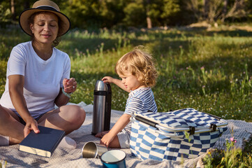 Mother and Child Enjoying a Serenity-Filled Picnic on a Warm Outdoor Day