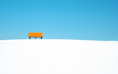 Solitary Orange Bench in a Snowy White Field Under a Vivid Blue Sky. High quality