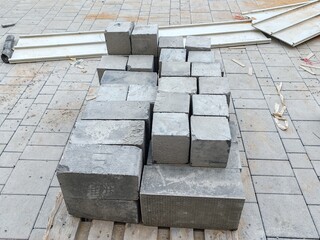 Interlock, Small bricks tile of pavement area
Interlock on Brown Sand
Interlock pallet on construction site for walking pathway or Padestrian crossing pavement
Interlocks on White Sandy ground surface