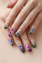 Beautifully decorated nails featuring vibrant floral designs in a serene setting