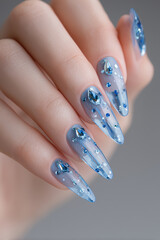 Elegant blue gemstone nail art showcasing intricate designs and sparkling accents for a stunning look