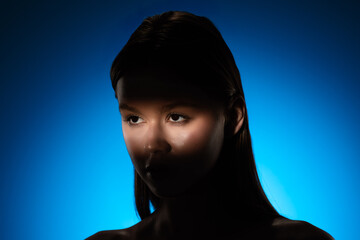 Captivating Portrait with Dramatic Shadow Play and Light Beam