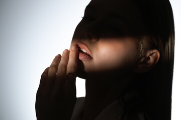 Artistic of Woman Wearing Unique Gold Ring in Dramatic Light Beam