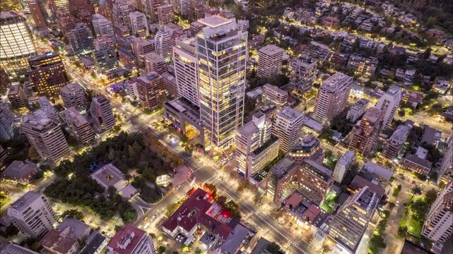 Santiago, Chile &ndash; May 23, 2024: Drone hyperlapse flying toward Hotel W in El Golf, Las Condes, showing surrounding towers and streets at dusk with city light