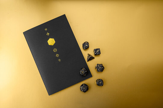 Game dice. Collection of beautiful multi-sided dice (d4, d6, d8, d10, d12 and d20) for fantasy games. Dice games and role-playing board games on a gold background.