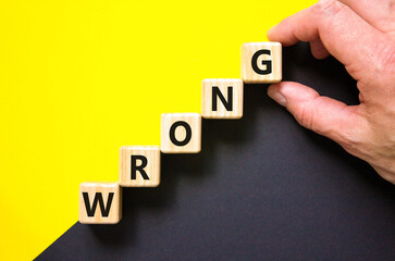 Wrong symbol. Concept word Wrong on beautiful wooden blocks. Beautiful yellow and black background....