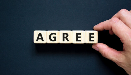 Agree symbol. Concept word Agree on beautiful wooden blocks. Beautiful black table black...