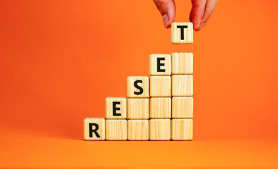 Reset symbol. Concept word Reset on beautiful wooden blocks. Beautiful orange table orange...