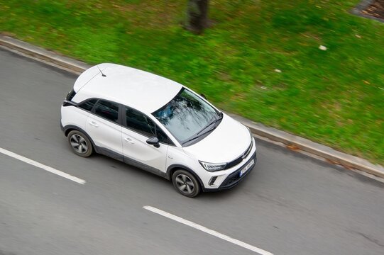 White Opel Crossland X crossover car with motion blur effect