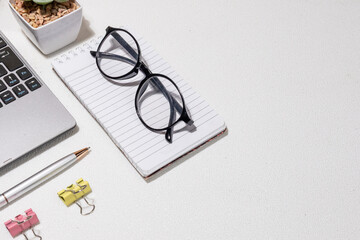Clean Desk, Clear Mind – Laptop and Supplies on White Office Surface