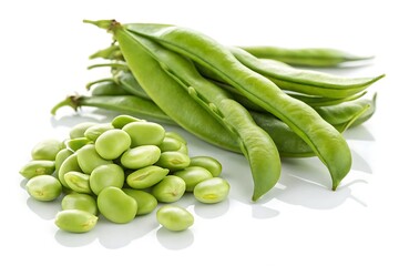 Fresh green fava beans and pods displayed on a white reflective surface