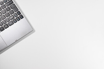 Top View of Minimal White Desk with Laptop – Modern Workspace Setup