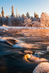 Mesmerizing frozen river in Norway at sunset with vibrant colors illuminating winter landscape