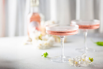 Homemade pink vodka cosmopolitan cocktail drink in crystal glasses