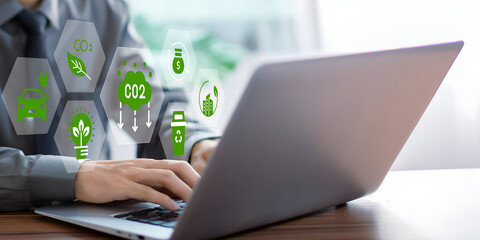 A business person using laptop with ESG environment social governance investment business concept,...