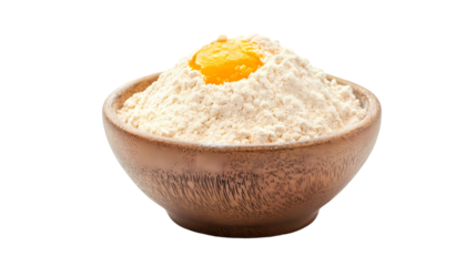 A wooden bowl filled with flour and a single egg yolk resting on top   isolated on transparent background