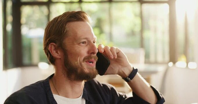 Phone call, talking and man in living room, home or smile for discussion with contact or networking. Happy, communication and person with mobile for conversation, relax or chat with tech in lounge