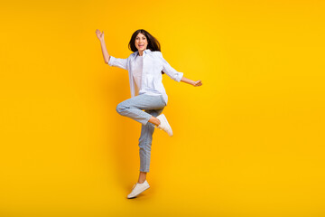 Full size photo of cool millennial lady jump up dancing excited wear shirt trousers isolated yellow color background