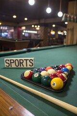 Colorful billiard balls, cue, and chalk on a green table with space for text.
