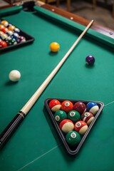 Top view of billiard cue aiming at pyramid of balls