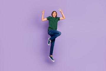 Full body photo of funny young guy jump air overjoyed funny funky isolated on purple background