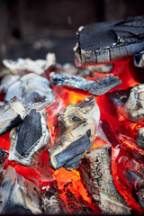 Close-up of large burning coals in a barbecue grill