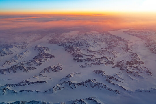 Aerial view of snow mountain and frozen river in colorful morning sunlight in Alaska