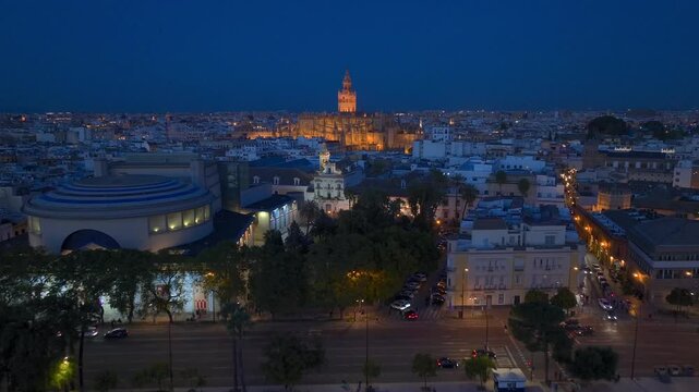 Gothic Cathedral of Seville at Night, Aerial Shot with Giralda bell tower in Seville Old town in Andalusia, Spain.