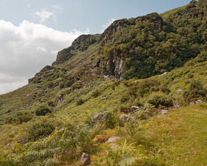 Scenic view of Strickeen mountain covered in lush green vegetation in the Gap of Dunloe, County Kerry, Ireland.