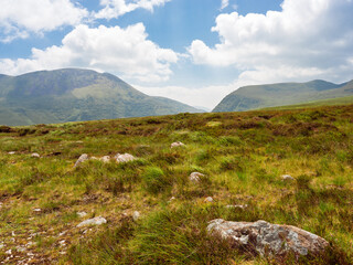 Scenic view of Strickeen mountain range against blue sky with clouds in County Kerry, Ireland, on a sunny day.