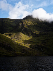 Lough Callee landscape showcasing rugged mountains, serene waters, and dramatic sky in Ireland during morning light.