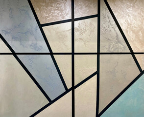 Abstract geometric wall design featuring pastel colors and diagonal shapes in a modern interior...