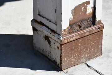 Rusted support pillar on old hotel.